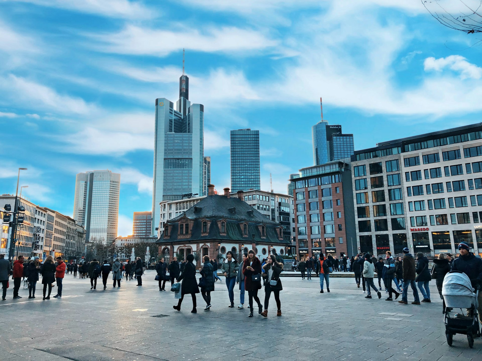 people walking on street near high rise buildings during daytime