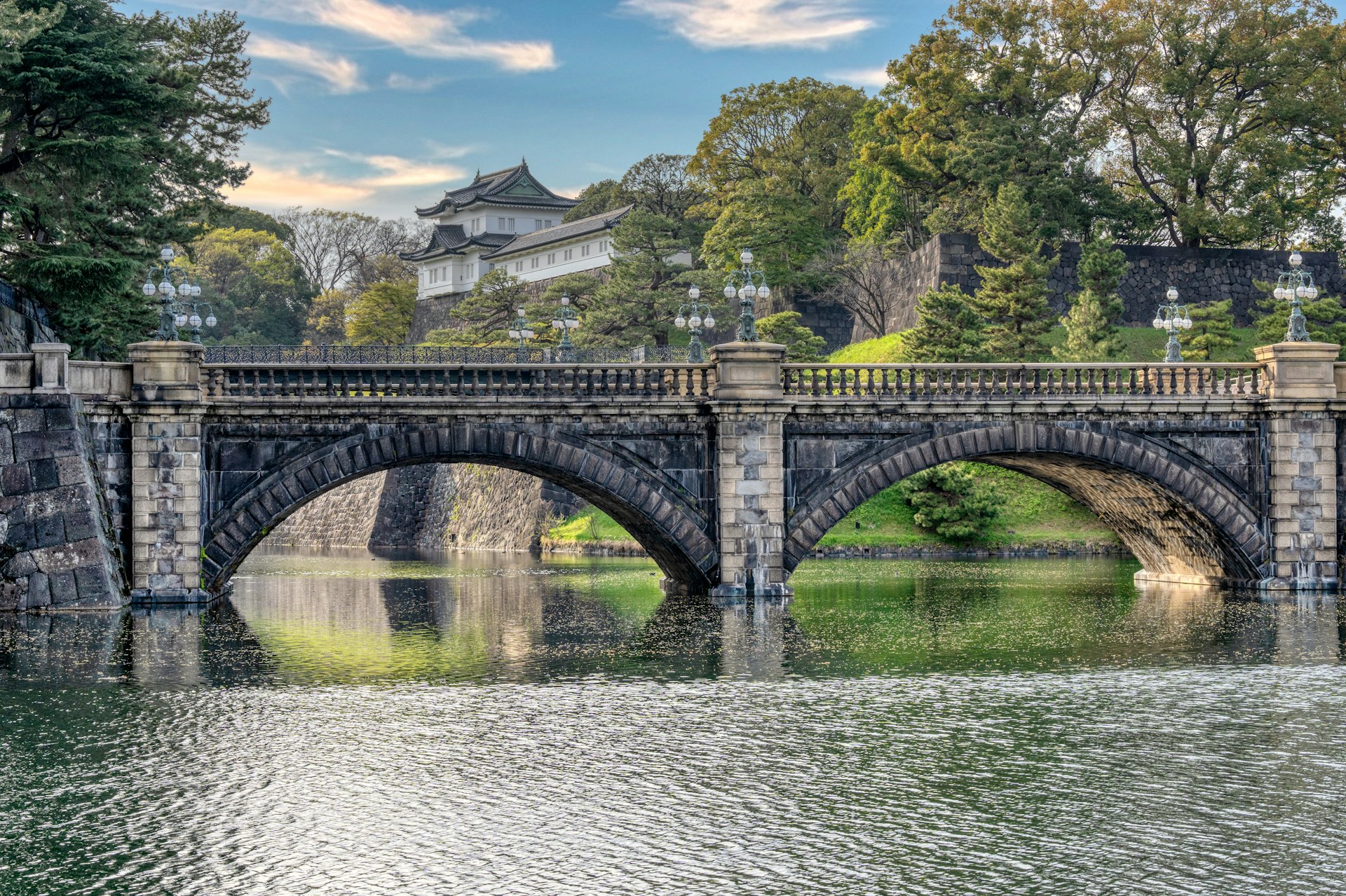 a bridge over a body of water with a building in the background