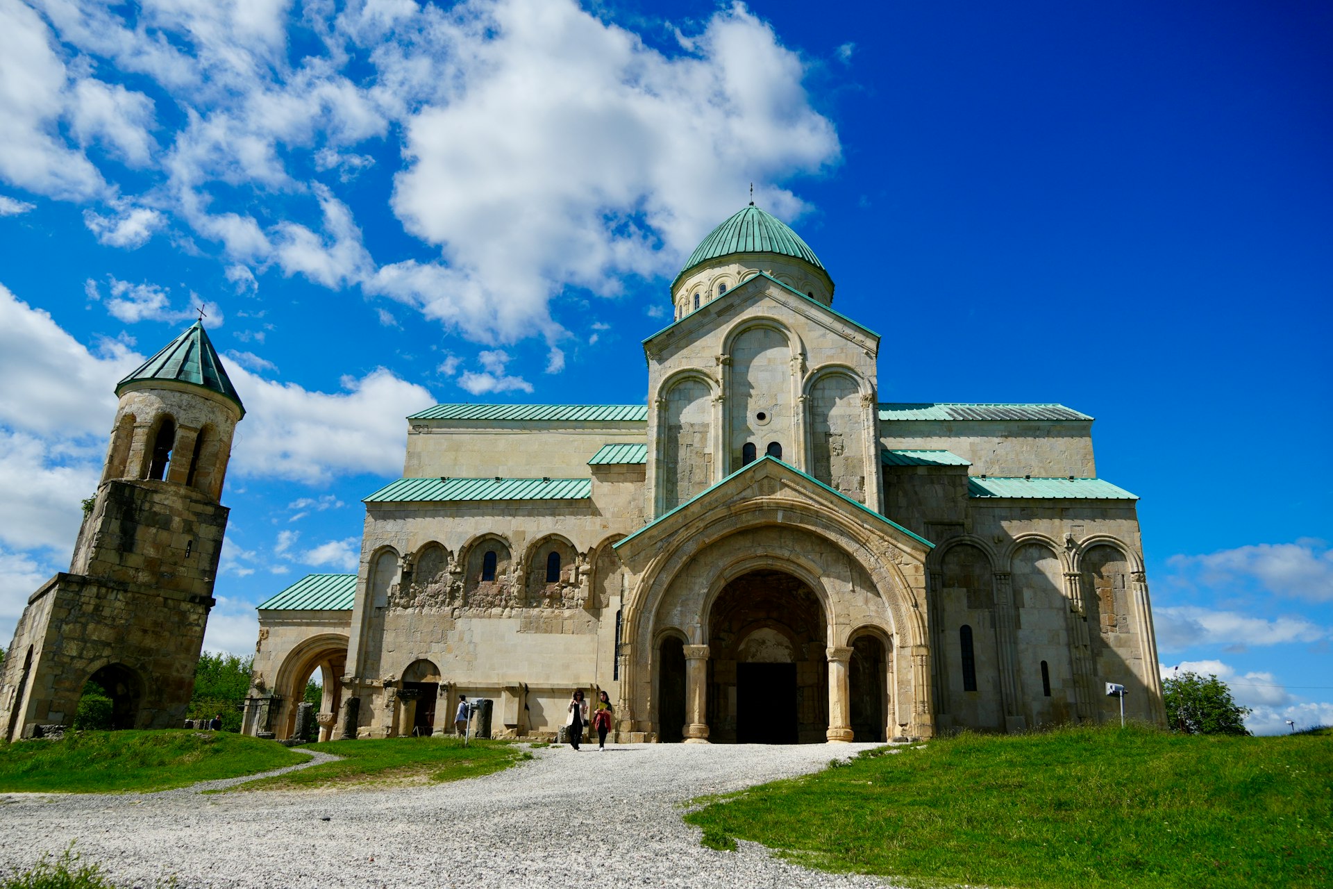 a large stone building with a green roof
