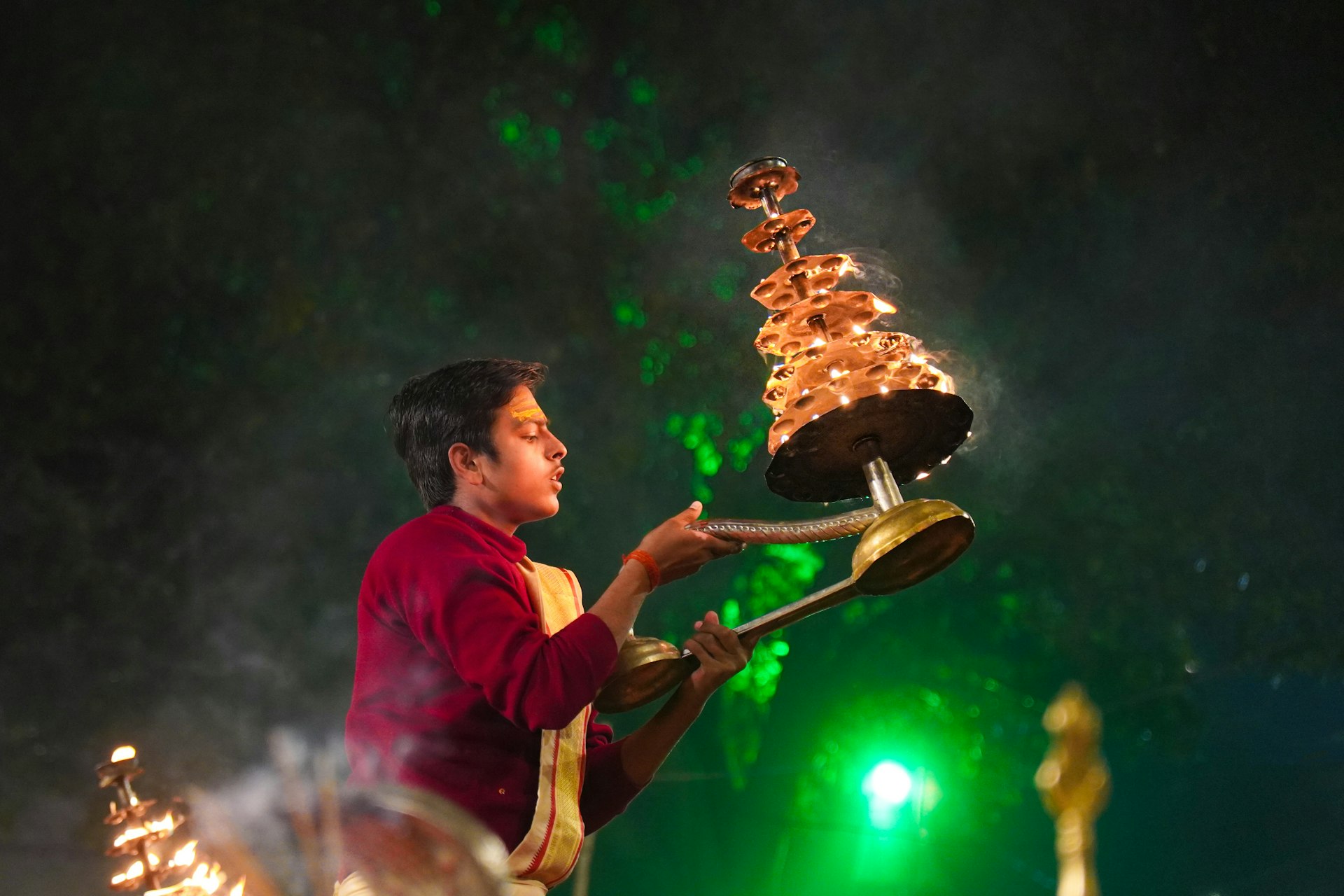 A man holding a large metal object on top of a stage
