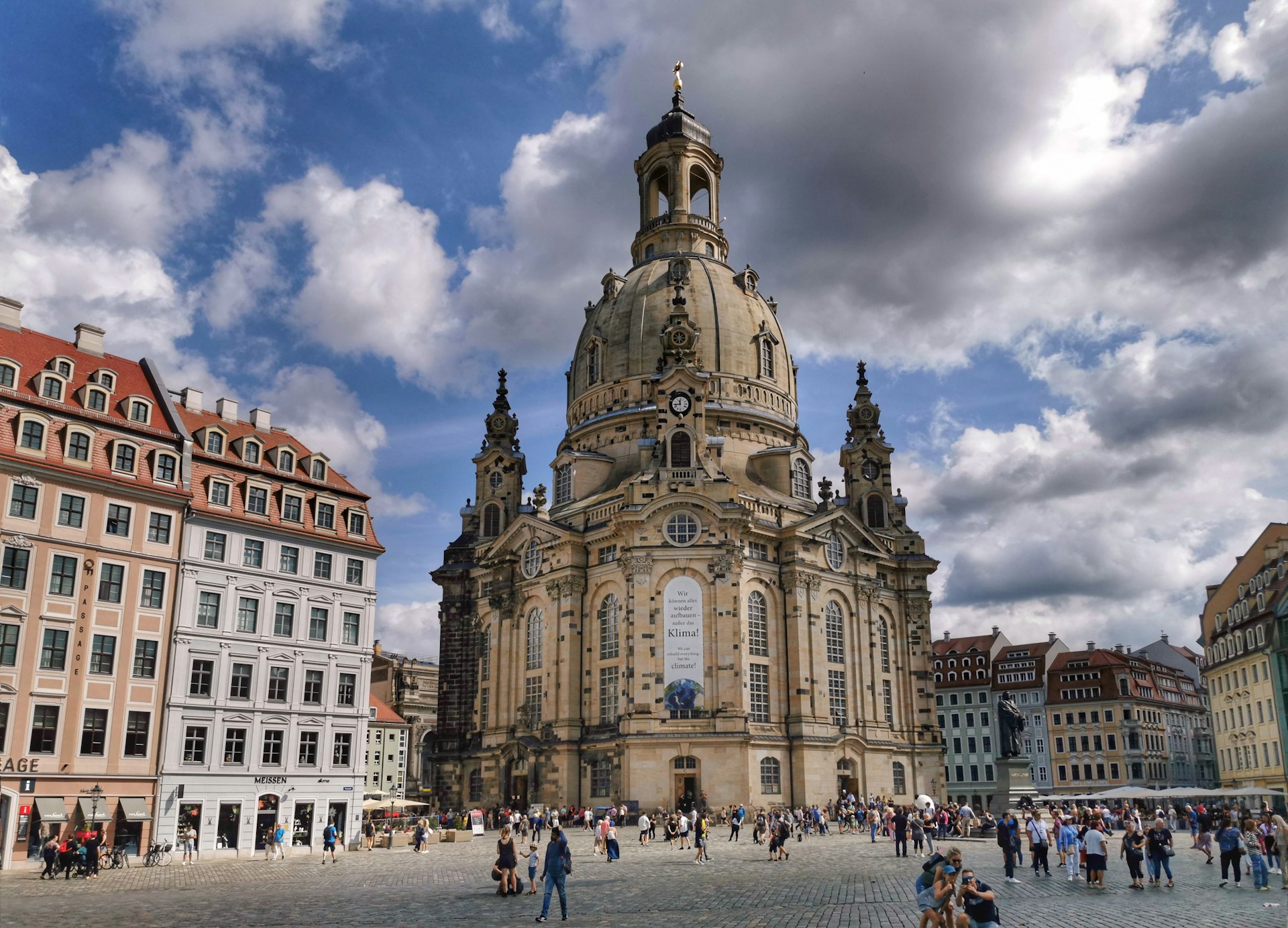 a group of people standing in front of a tall building