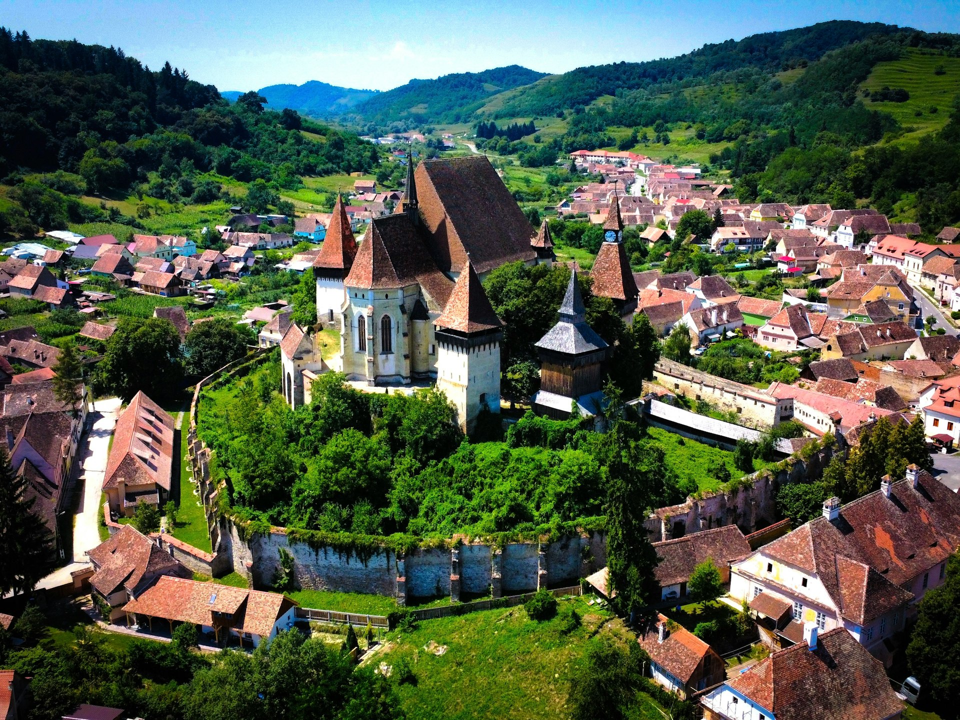 An aerial view of a village with a river running through it