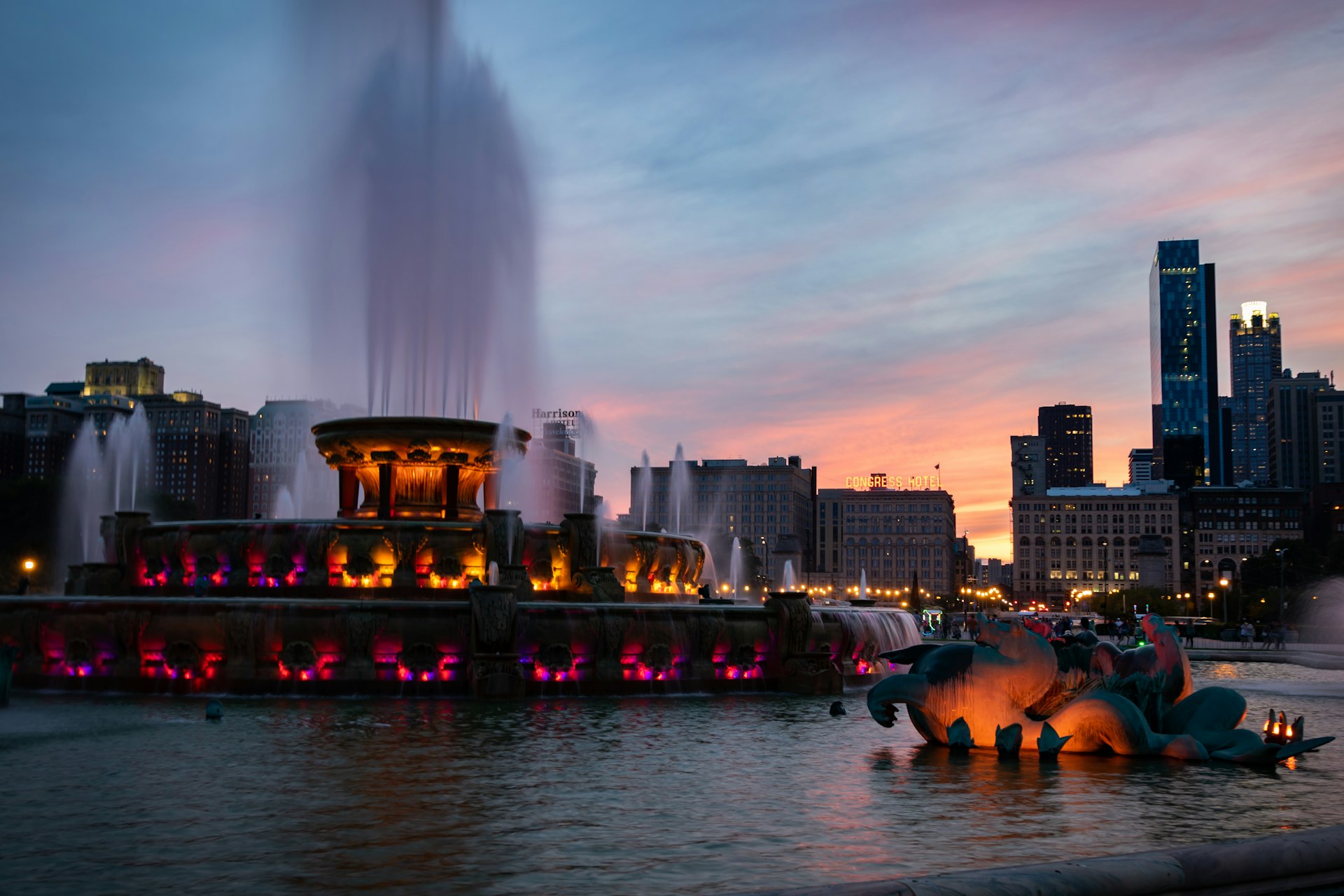 lighted water fountain near buildings