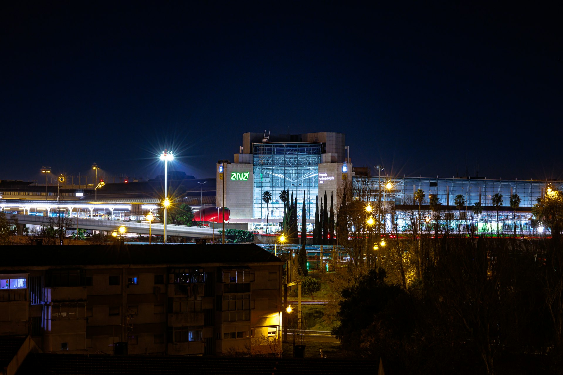a city at night with a train on the tracks