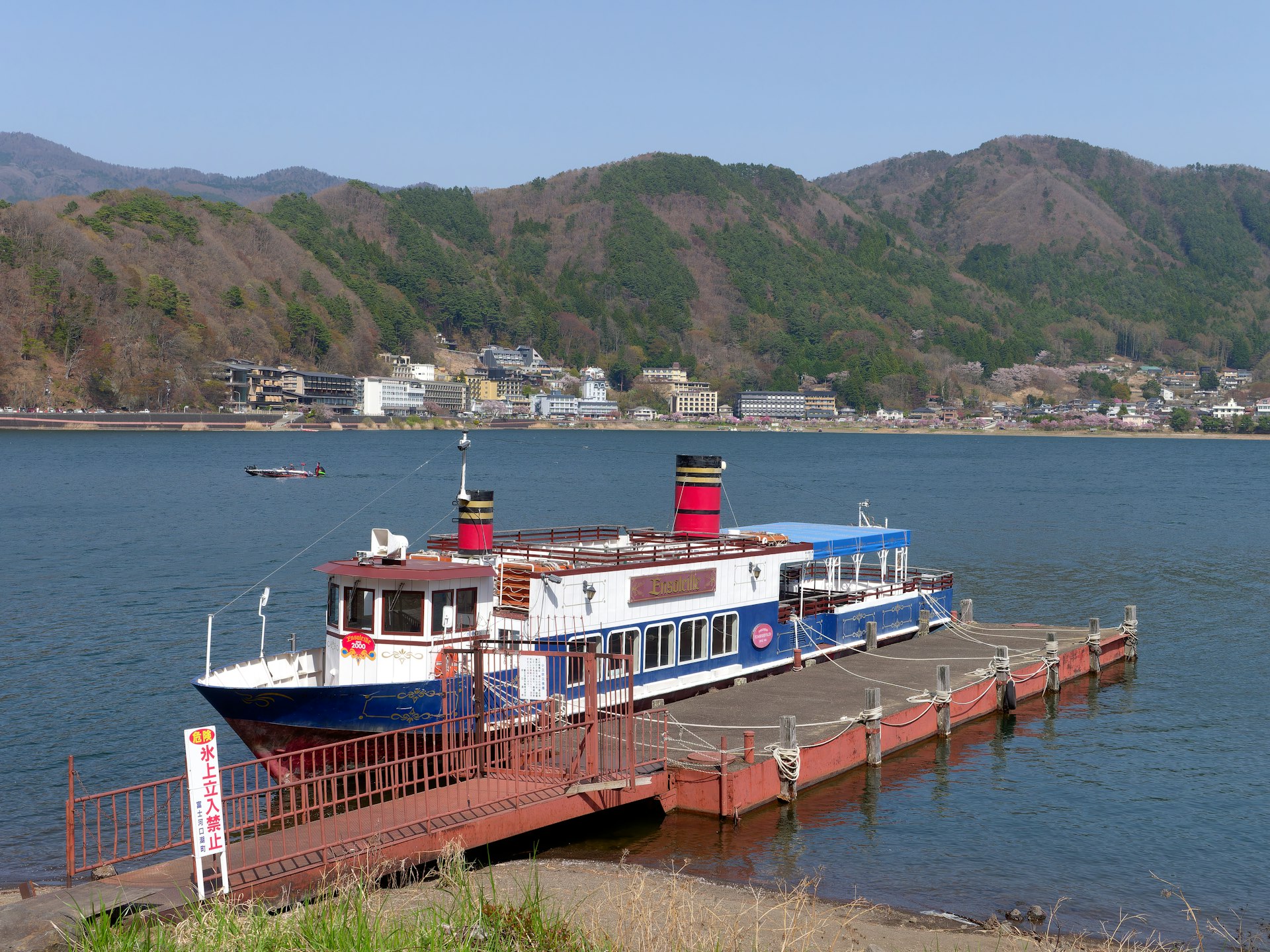 a blue and white boat docked at a pier