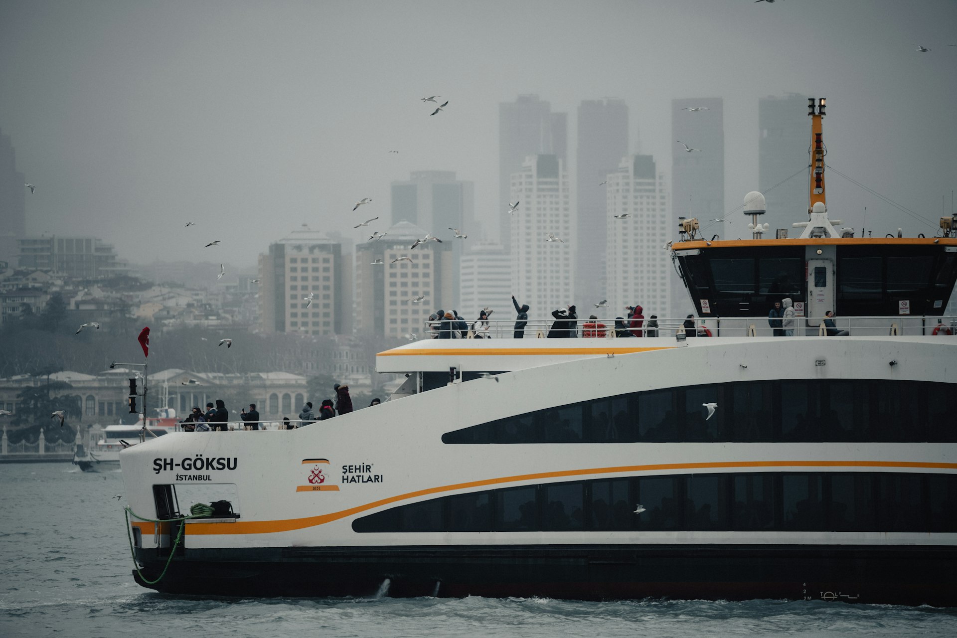 A large white and orange boat in a body of water