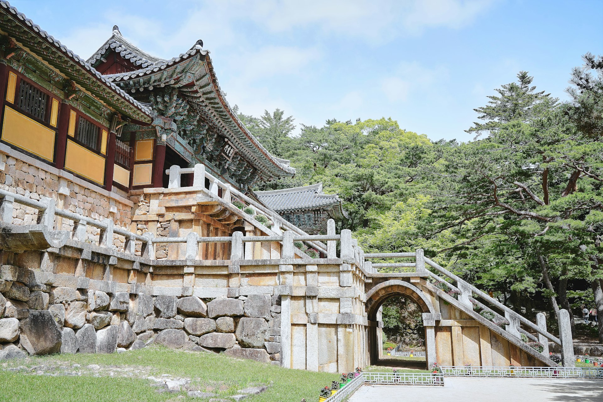 a stone building with a gate and steps leading to it