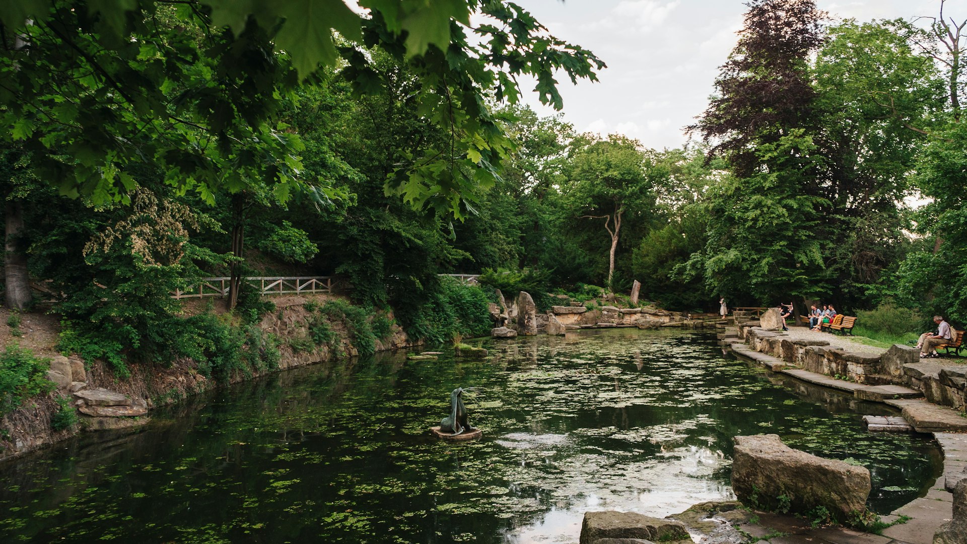 people are sitting on the edge of a river