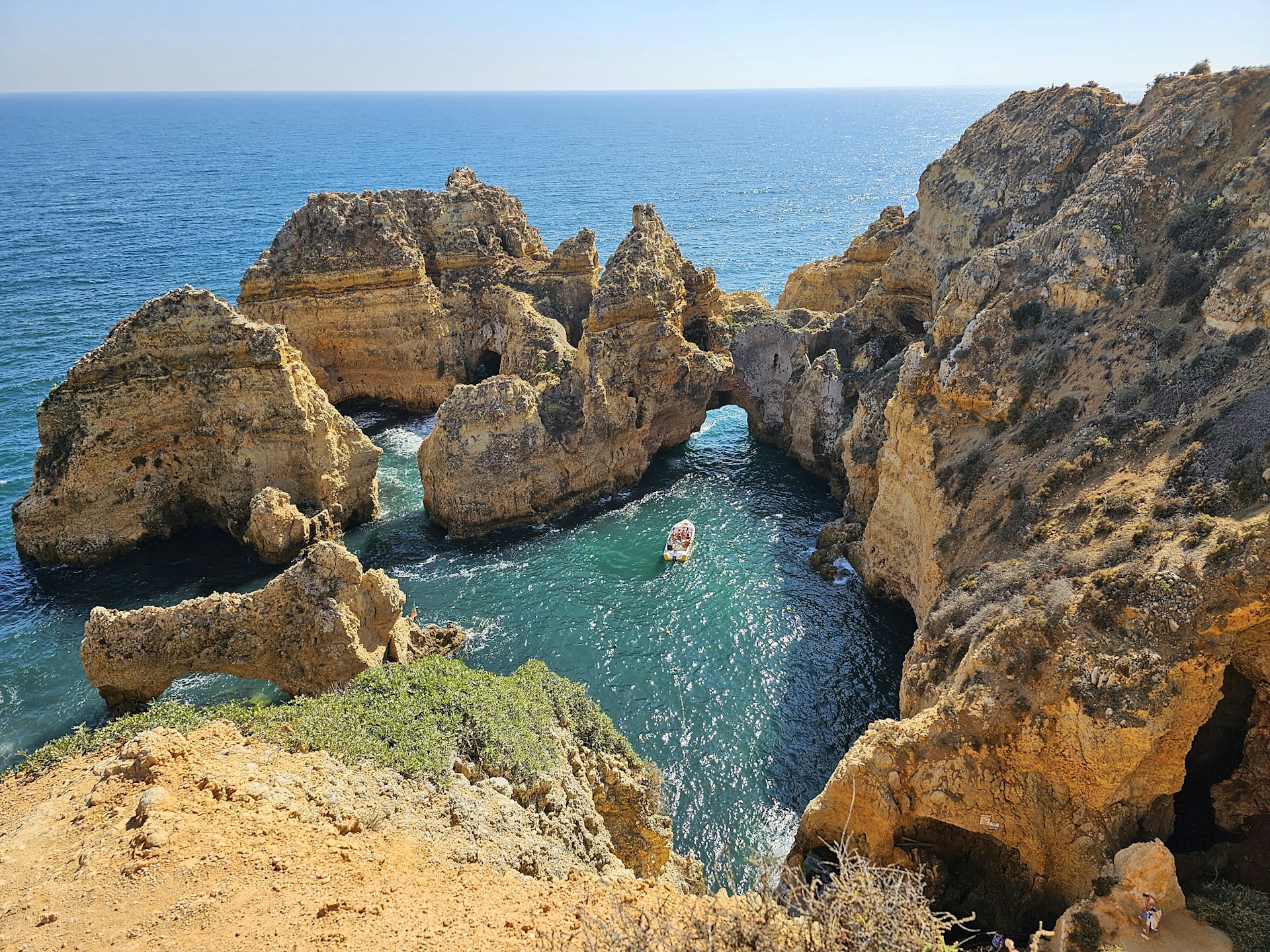 a boat is in the water between two large rocks