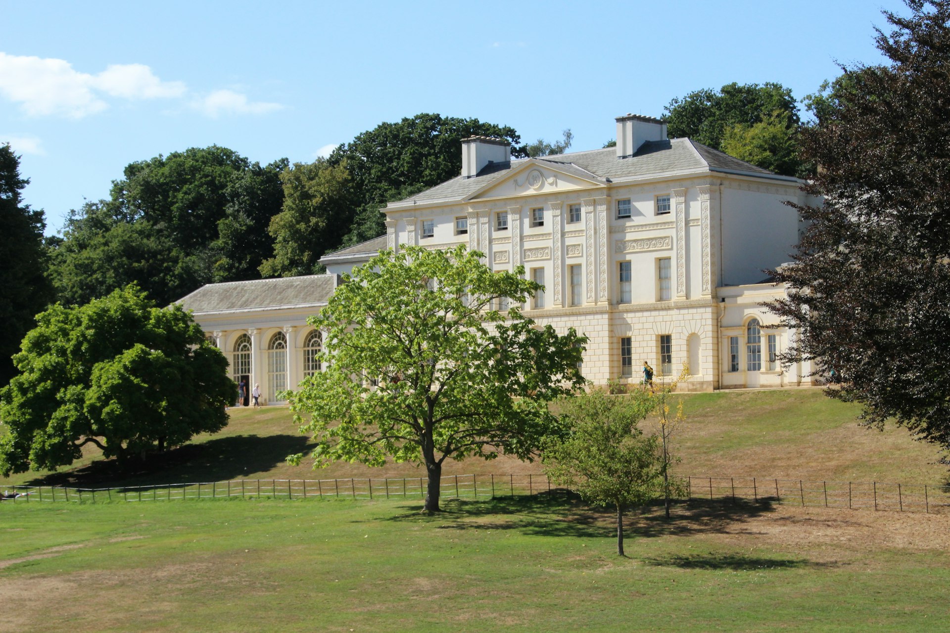 a large white building with trees in front of it