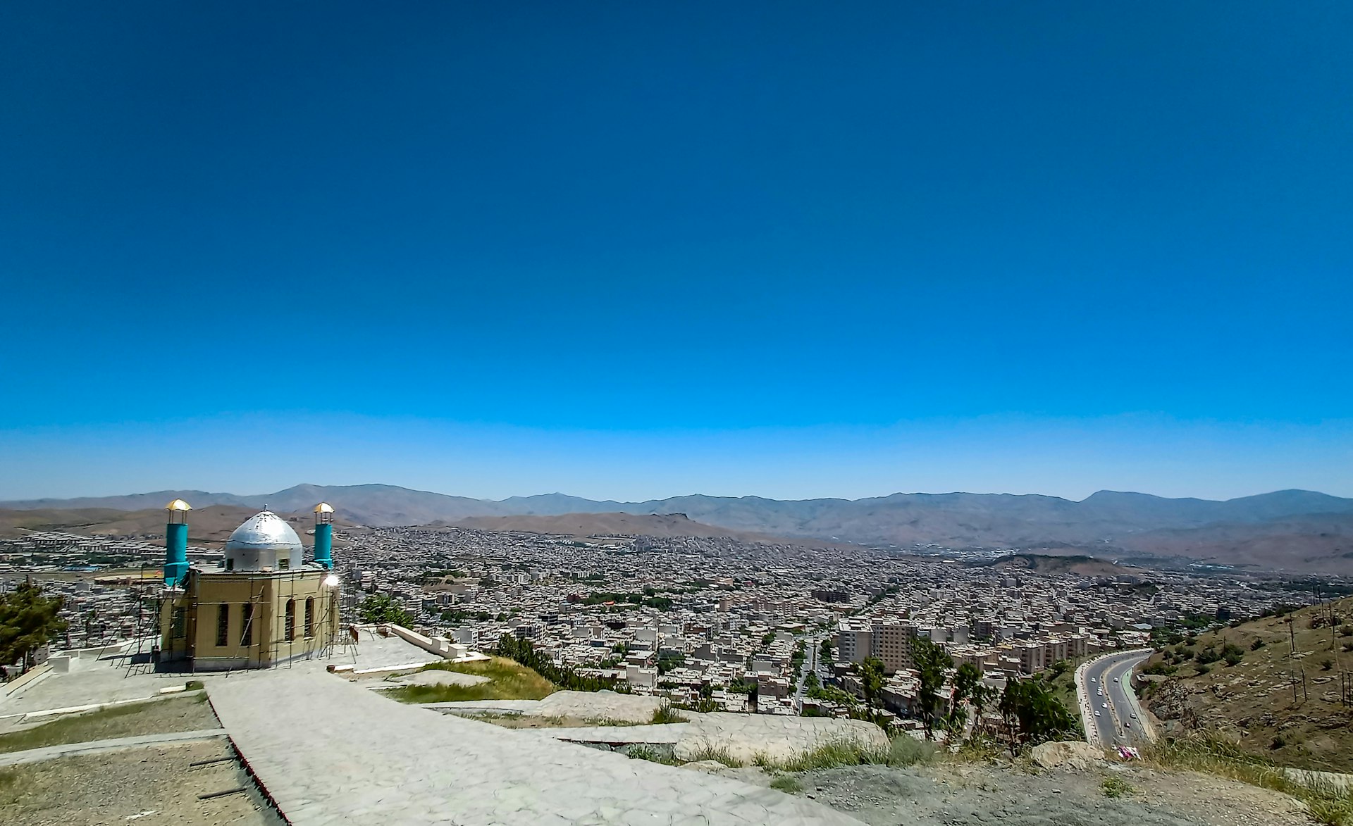a scenic view of a city from a hill