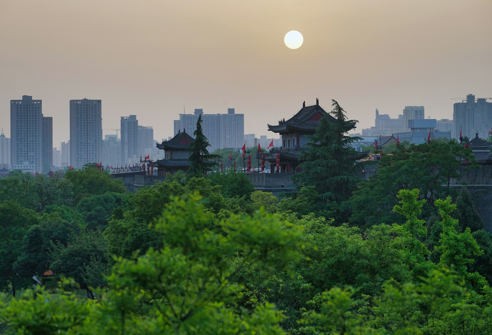 The sun is setting over the city skyline